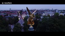 Illuminated hang glider swoops into Munich
