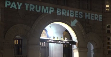 'Pay Trump Bribes Here' Projected Over Trump Hotel Doorway
