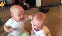 Twin baby girls fight over pacifier