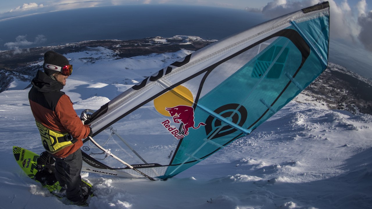 Daredevil Windsurfs Down A Snowy Mountain