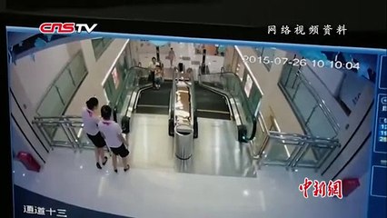 Woman pulled by escalator