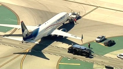 8 injured after passenger jet collides with utility truck at Los Angeles airport