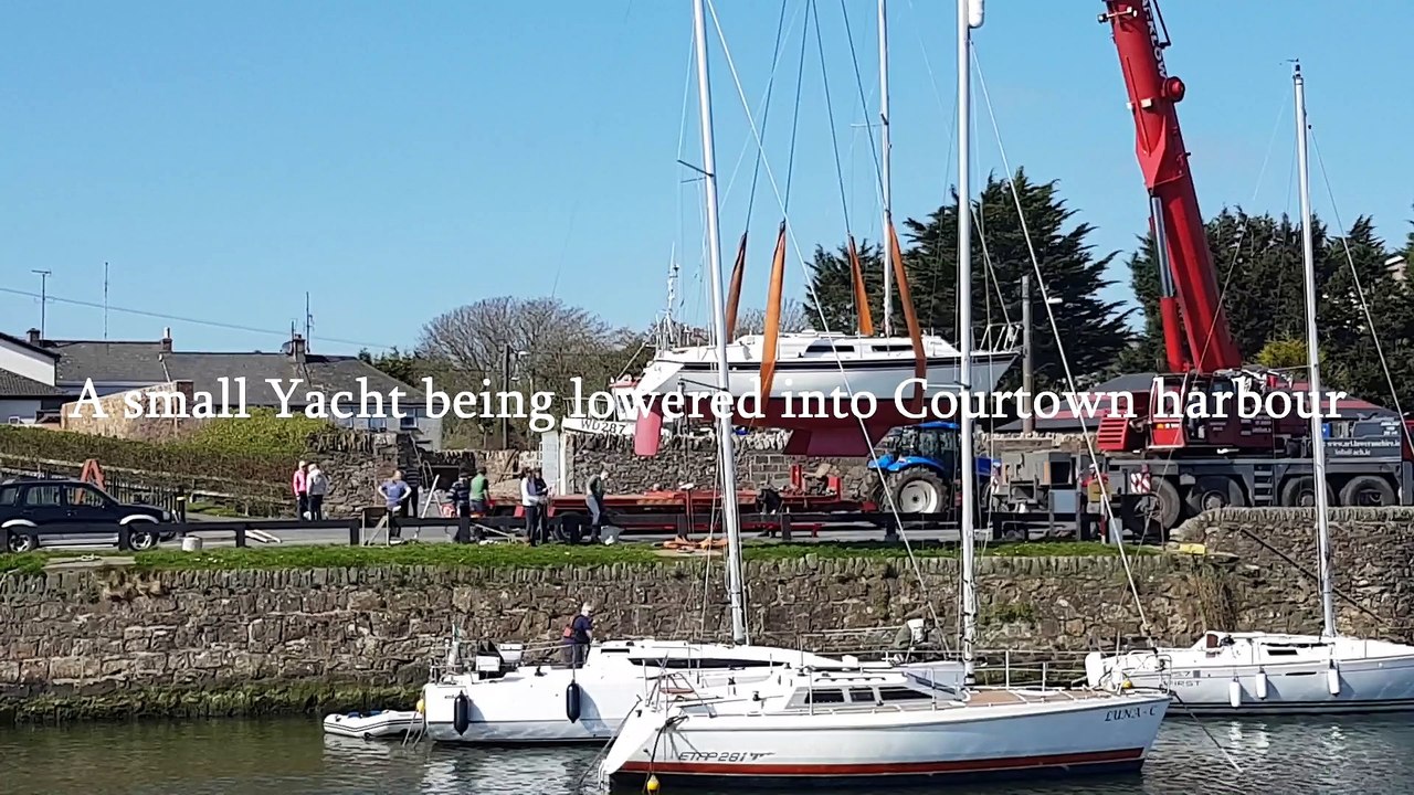 A small yacht being lowered into Courtown harbour