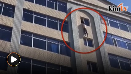 Firefighters save drunk man from jumping off building in China