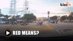 Red light means stop but motorcyclist speeds through intersection