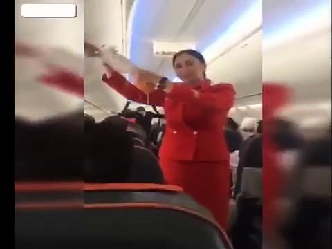 Football fans distracting the Air Hostess on flight during the safety announcement-ea4
