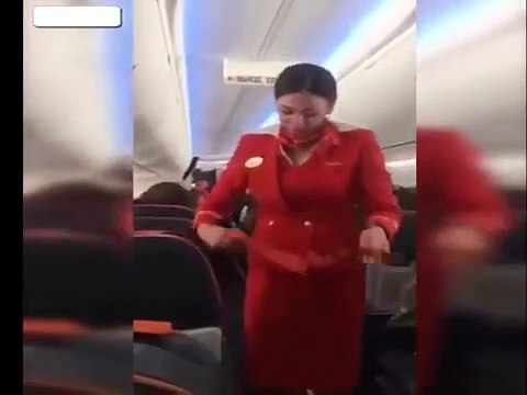 Football fans distracting the Air Hostess on flight during the safety ann