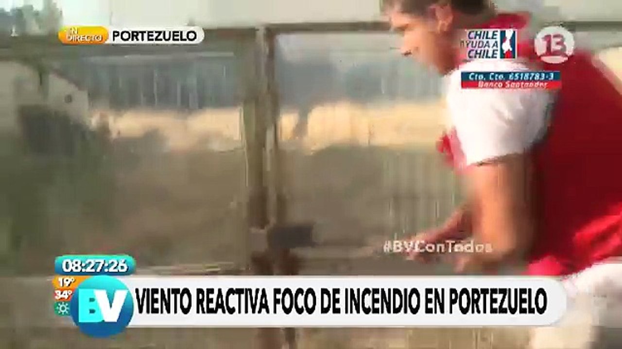 Guy rushes to open gate for firefighters as wind rises a forest fire in Chile