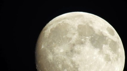 Amazing close up footage of an early evening full moon moving across the sky
