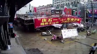 RAW  Scaffolding holding up a market stall in China dramatically
