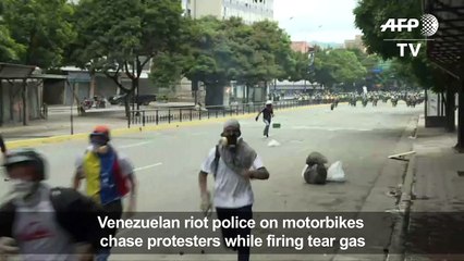 Police on motorbikes chase down protesters in Caracas