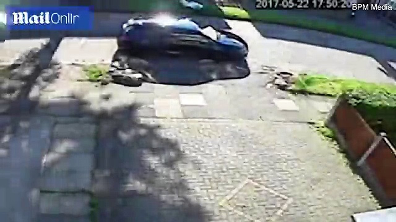 Shocking moment brave mother, 40, REVERSES her vehicle 'to escape three masked carjackers who charge at her waving weapons'