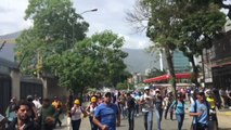 Caracas Protesters Run From Tear Gas