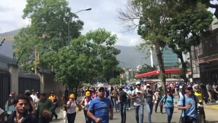 Caracas Protesters Run From Tear Gas