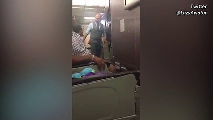 Armed police escort the alleged attempted hijacker off the plan