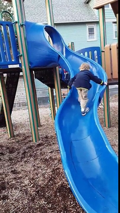 Aden and Ethan playing with their monster truck toys on the slides 1