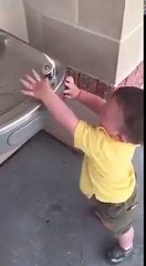 Baby Trying to catch the water