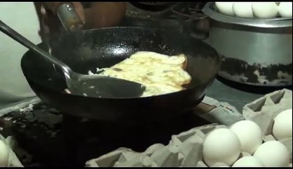 The man cooks the fried egg and gives it to the customer on the sandwich amazing
