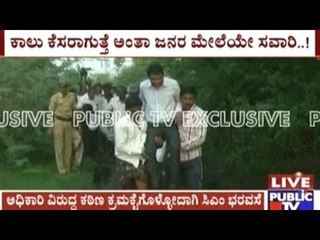 Zilla panchayath CEO carried by villagers to cross a muddy puddle in Raichur