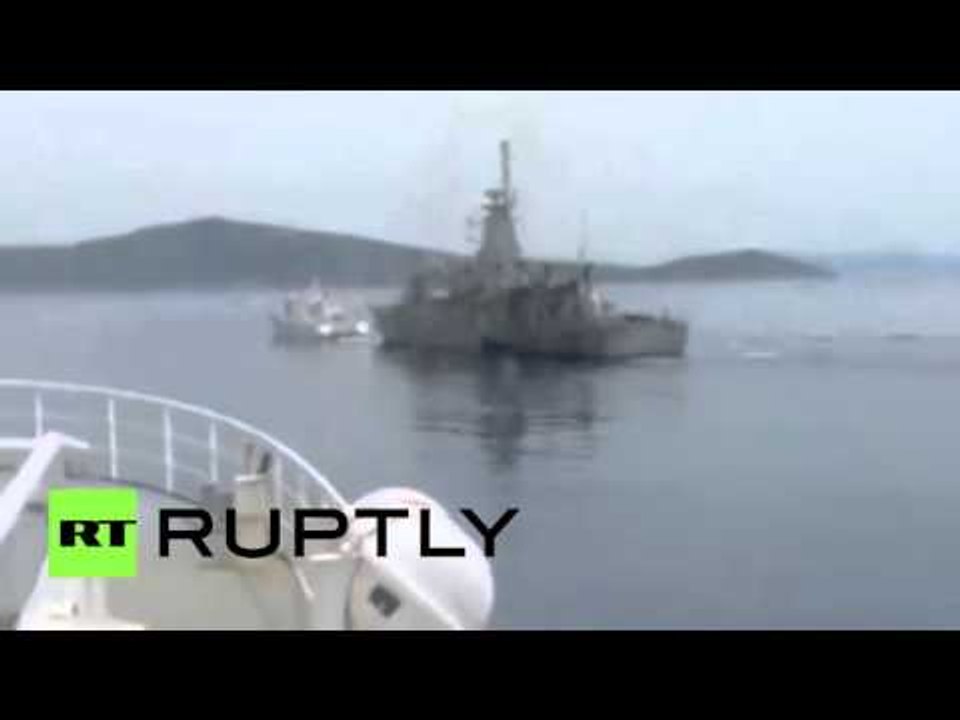 Greek navy gunship chasing Turkish coastguard threatening Greek fisherman