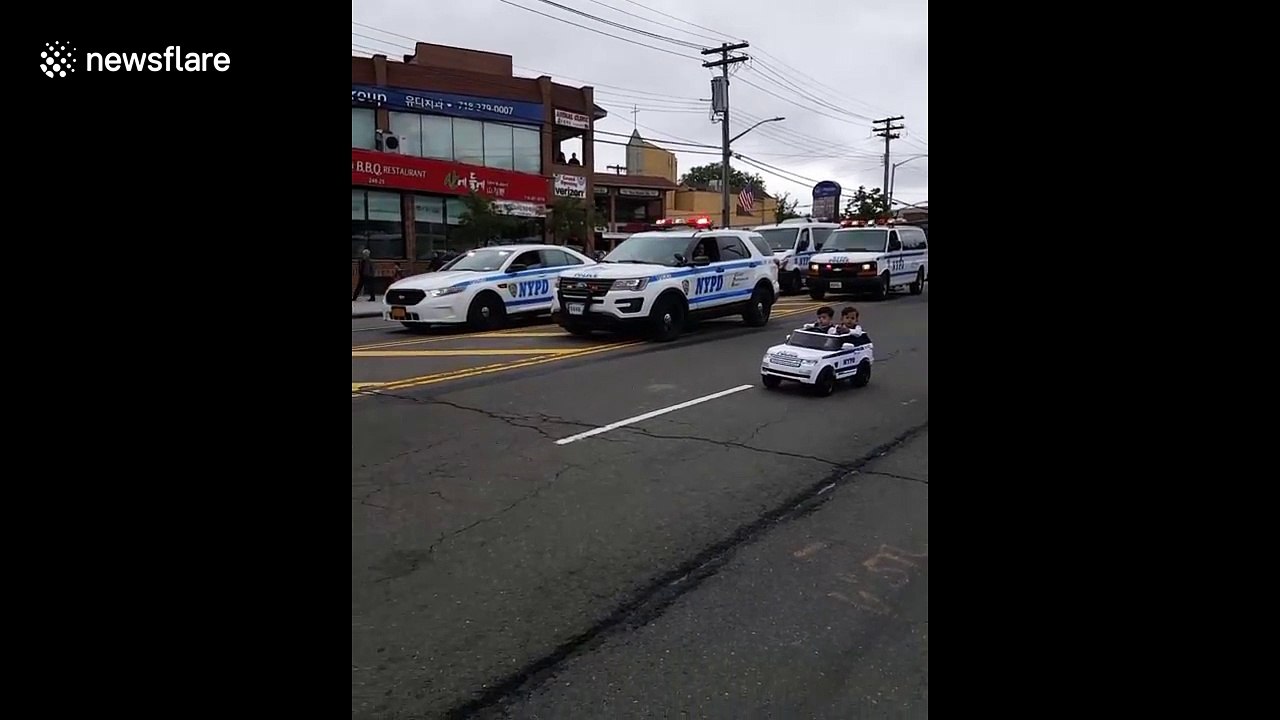 Twins, 2, drive in mini police car alongside NYPD officers
