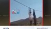 Farmers hold hightension electric wire in a way to protest for more compensation