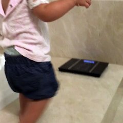 Cute baby checking weight hahahahah
