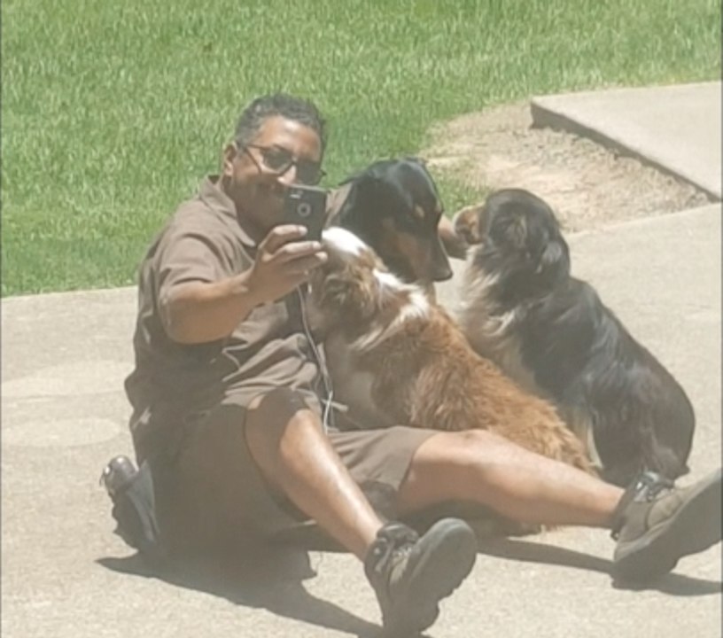 UPS Man Takes a selfie with some friendly Dogs