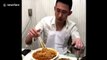 Chinese man uses scissors to shorten noodles while eating