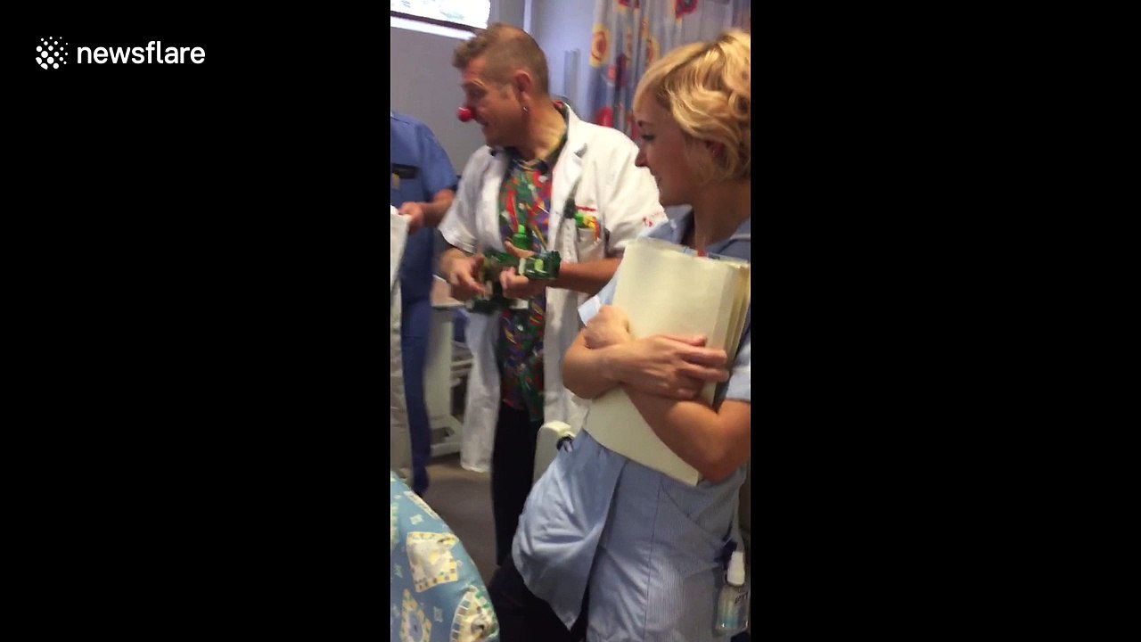 Clown doctors serenade boy before he receives heart surgery