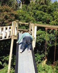 Trevor slides down the slide