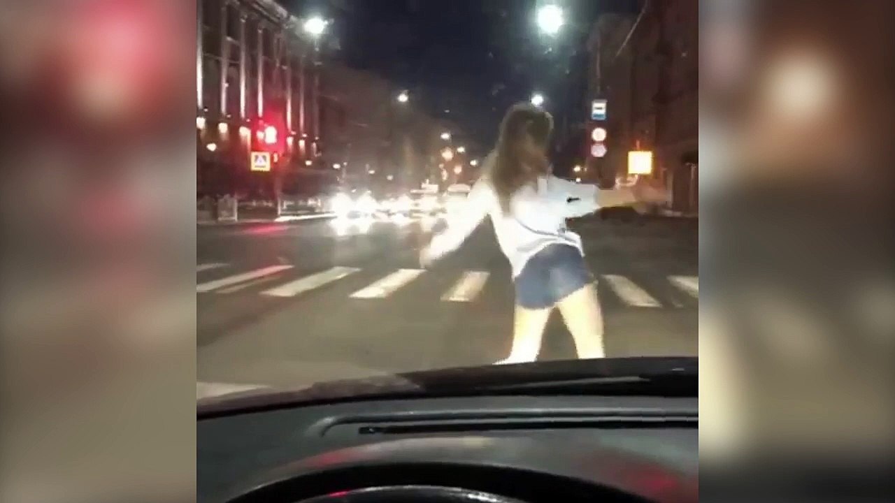 Une jeune femme se met à danser devant une voiture !