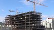 Time-lapse  Wide view of tower cranes with flowing clouds (4