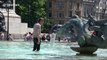 Londoners jump into Trafalgar Square fountains to cool down