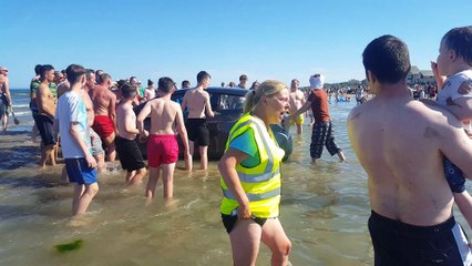 Crowd Saves Car From the Sea