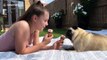 Girl and pug cool down by enjoying an ice cream together