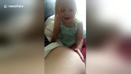 Girl feels baby brother kick in her mother's belly