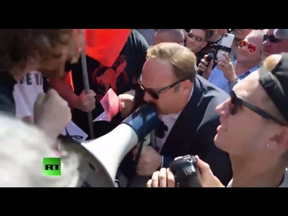 Infowars frontman Alex Jones faces & fights anti-Trump protesters