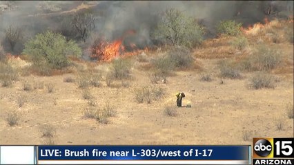 Air15 over a brush fire near the Loop 303 and I-17