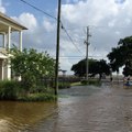 High Tide Causes Floodwaters to Reach Buildings Along Mandeville Lakefront