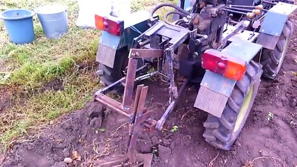 Homemade tractor digging potatoes