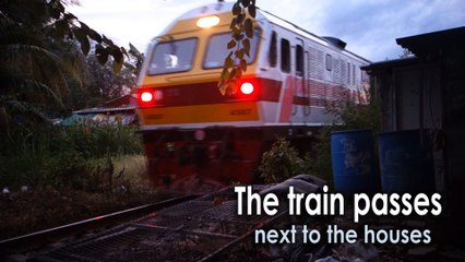 The train passes next to the houses