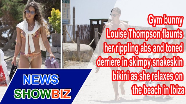 Gym bunny Louise Thompson flaunts her rippling abs and toned derriere in skimpy snakeskin bikini as she relaxes on the beach in Ibiza