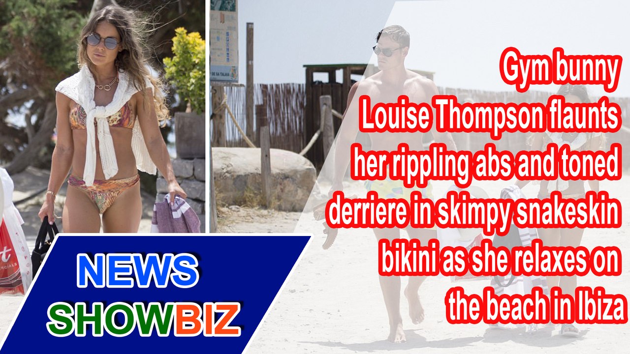 Gym bunny Louise Thompson flaunts her rippling abs and toned derriere in skimpy snakeskin bikini as she relaxes on the beach in Ibiza