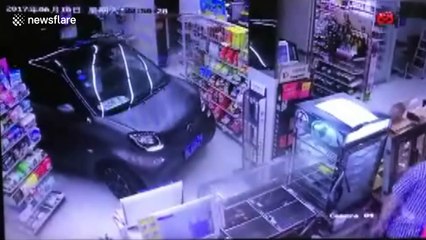 Man drives Smart Car into shop on rainy day