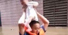 Police Officer Carries Baby Overhead in Chest-High Chinese Floodwater