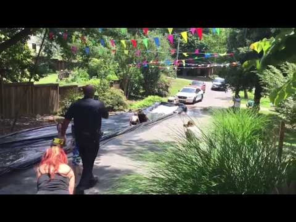 Police Officer Joins Slip 'N Slide Fun