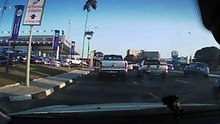 Car gets pushed off road by truck.