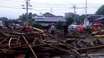 Tree Branches and Debris Strewn Across Asakura Streets Following Flooding
