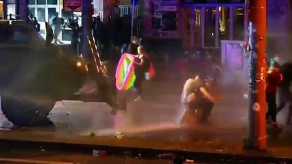 G20 protesters refuse to move, blasted by police water cannon